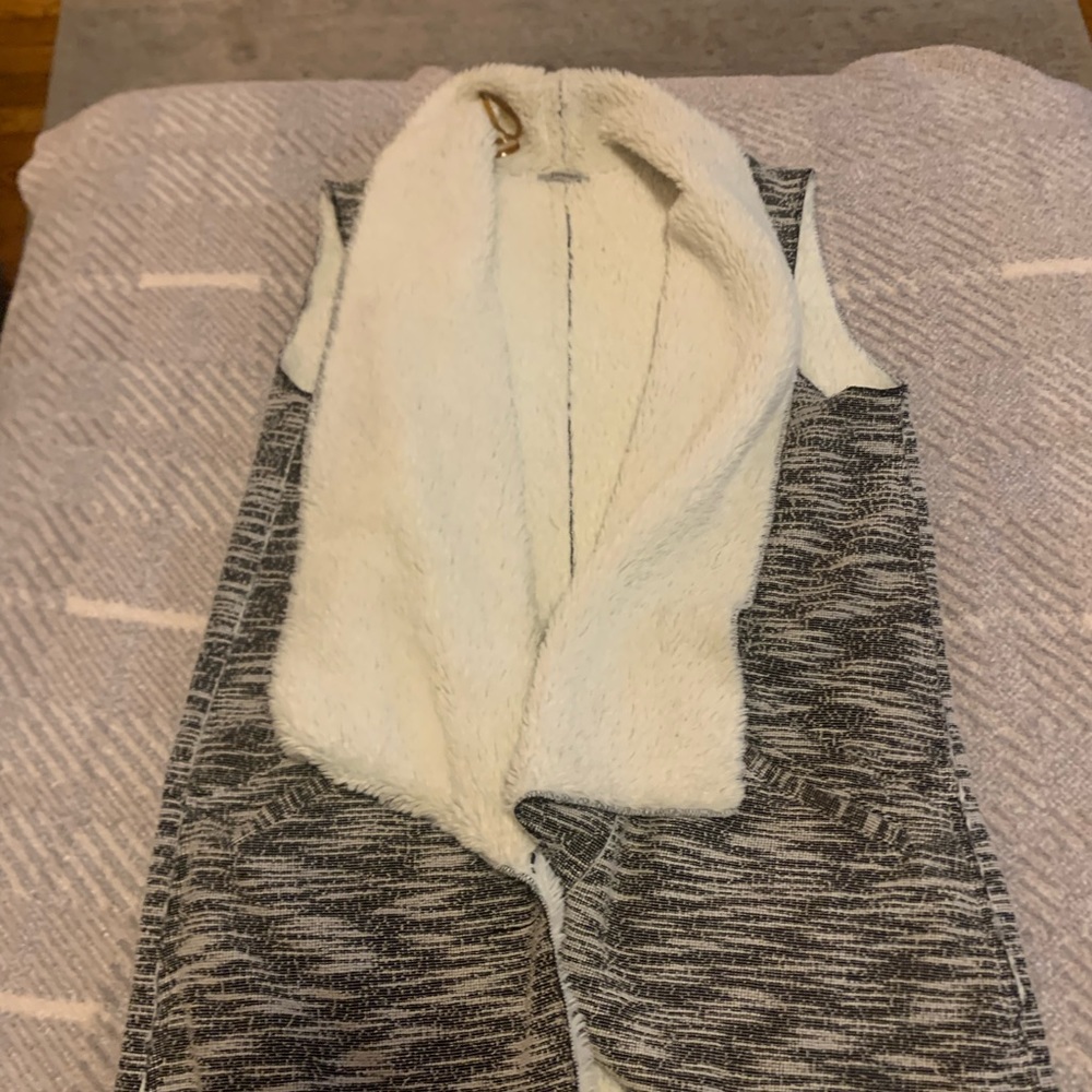 Black and white vest with white faux soft plush fabric.